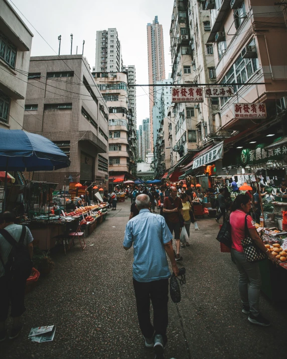 a crowd of people walking through a street