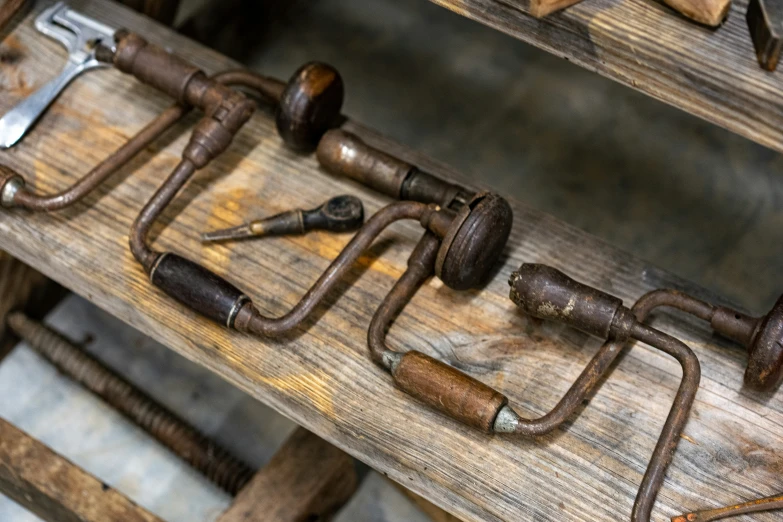 several different tools are attached to a wooden surface