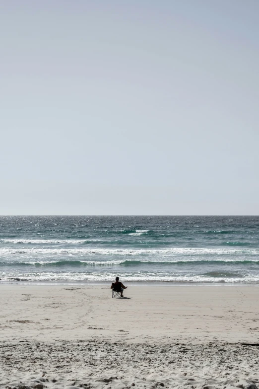 a person on a beach with a surfboard