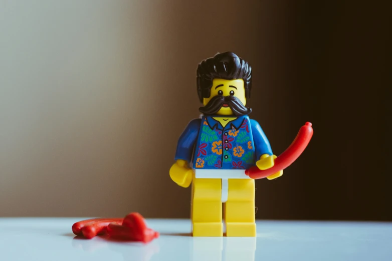 a lego figure next to candy cane with mustache