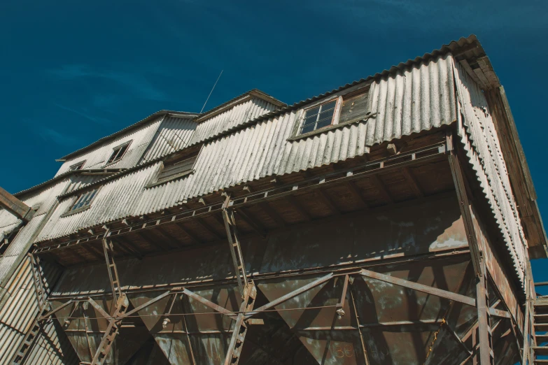 an old building has metal stairs and a brick chimney