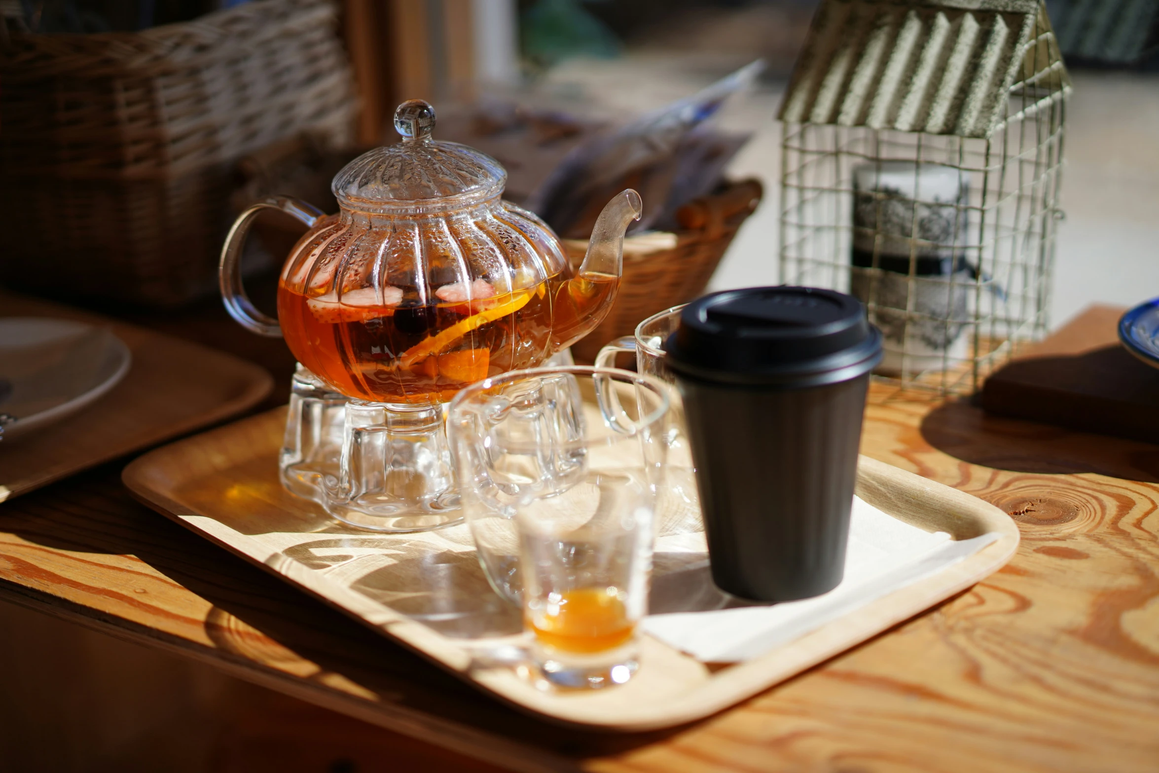 tea and other coffee on a tray with a metal cage in the background