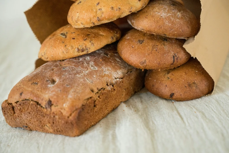 a large pile of bread is sitting on the bed