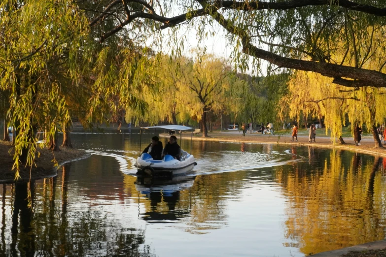 two people in a small boat on a river