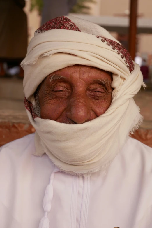 a man with a head wrap wrapped around his face