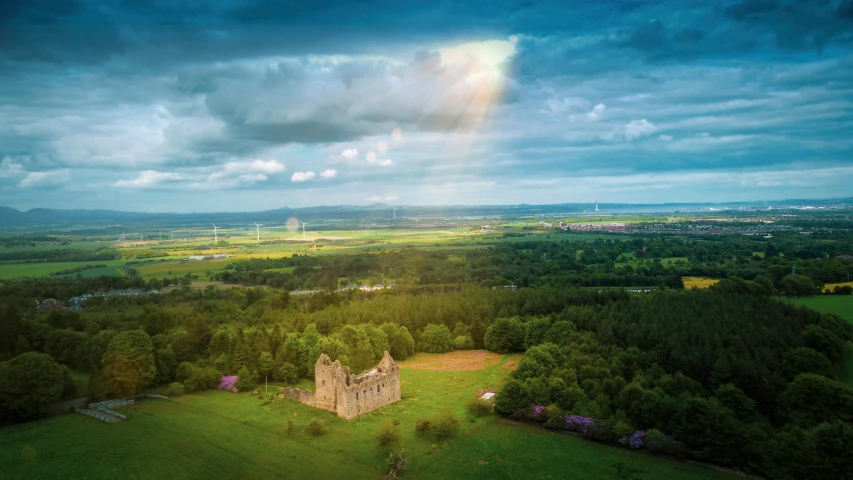 an image of a colorful rainbow in the sky over green land