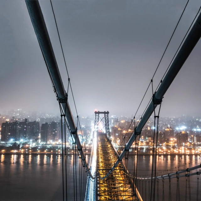 the suspension bridge and a night time view of a city