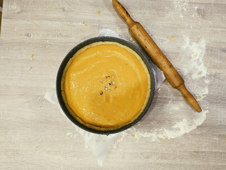 a baked dessert is shown in a bowl and next to a spoon