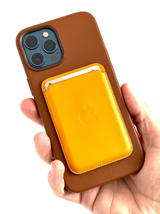 someone holding an iphone 11 and an iphone 11 wallet case