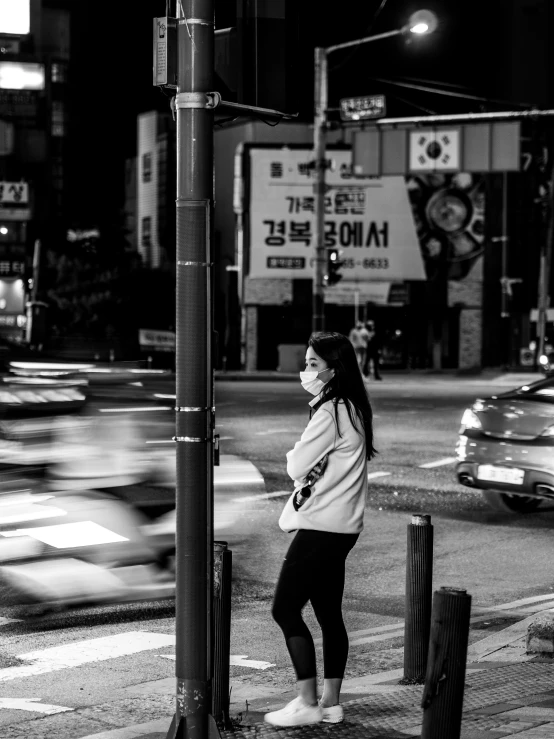 a woman is standing at a cross walk