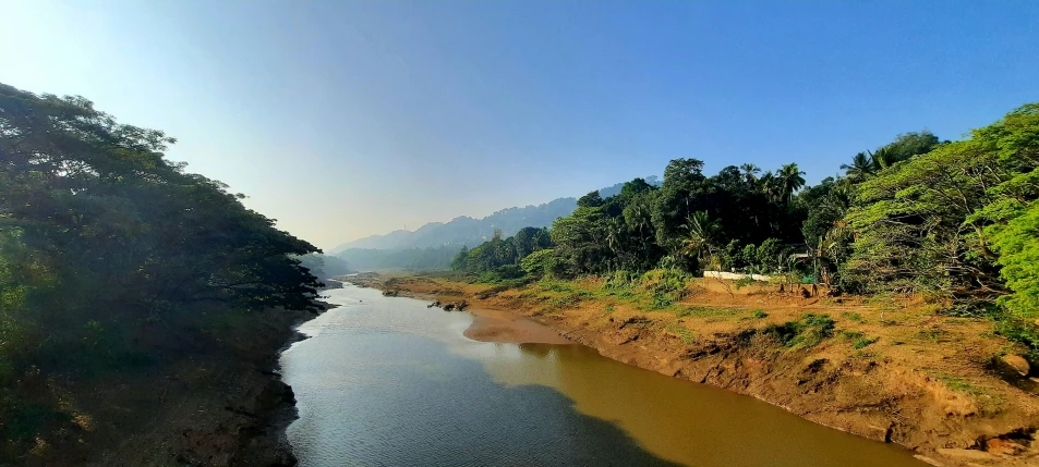 the sun shines on an empty river