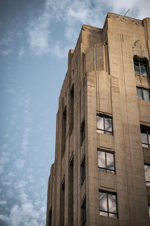 the top of the building with two windows and a bird on top