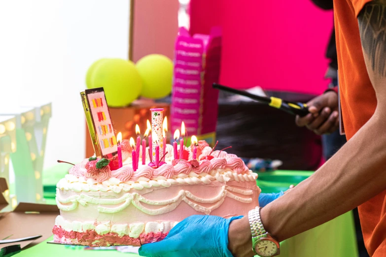 a woman that is standing in front of a birthday cake