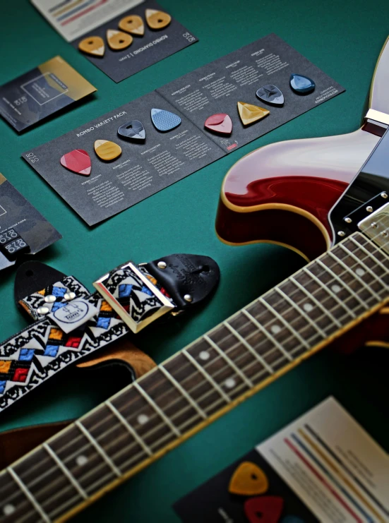 a colorful electric guitar sitting on a green table