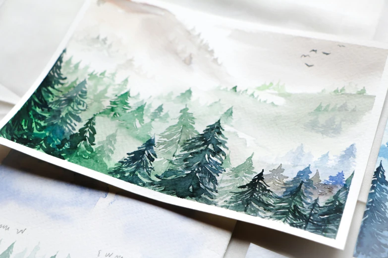 the green and white trees on the landscape are painted on paper
