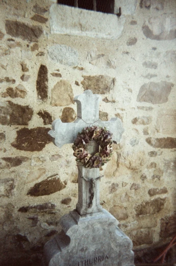 a stone wall with a wreath on top