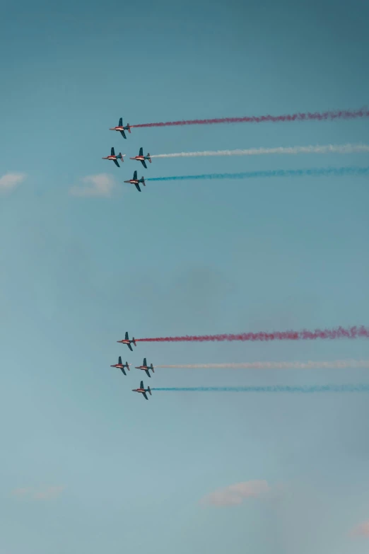a formation of planes that are flying in the sky