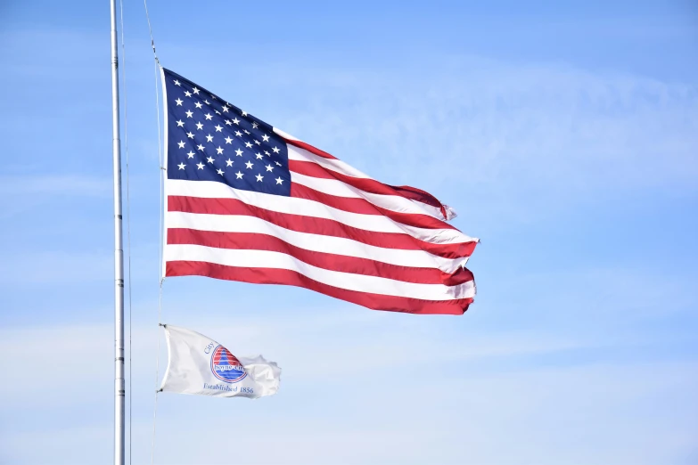 a group of two flags flying next to each other