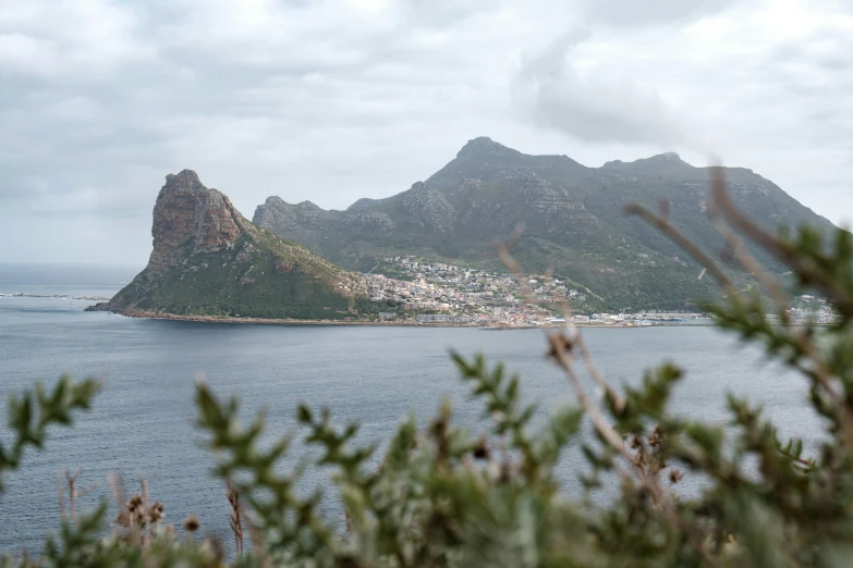 a small island near a body of water in the middle of a cloudy sky