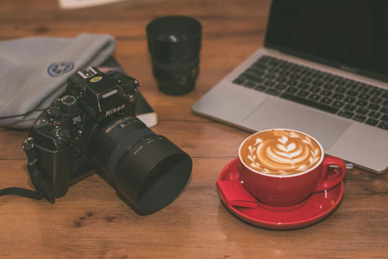 a coffee cup and camera on the table