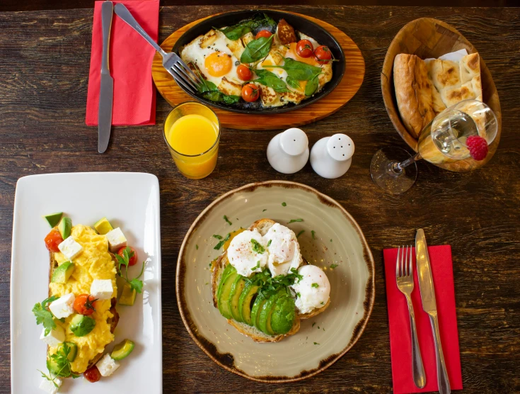 three plates and glasses on a table with food