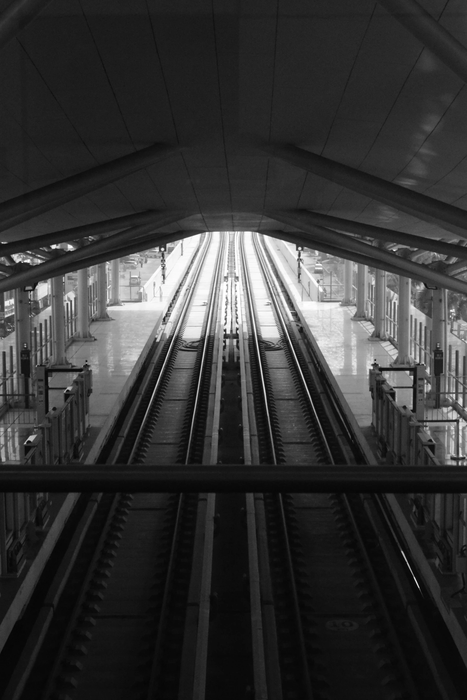 a monochrome pograph of an overhead train track