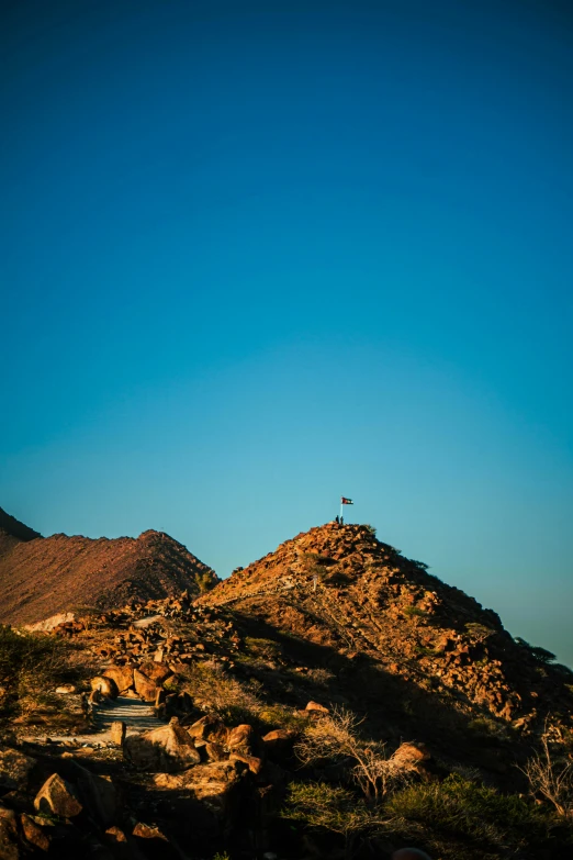 a mountain with some hills and people on it