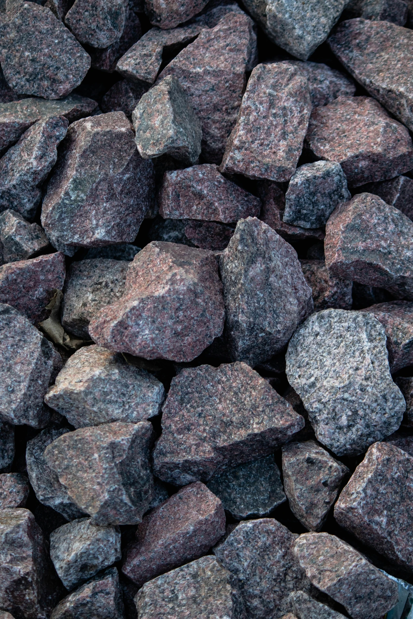 small rocks are laying together with black stuff