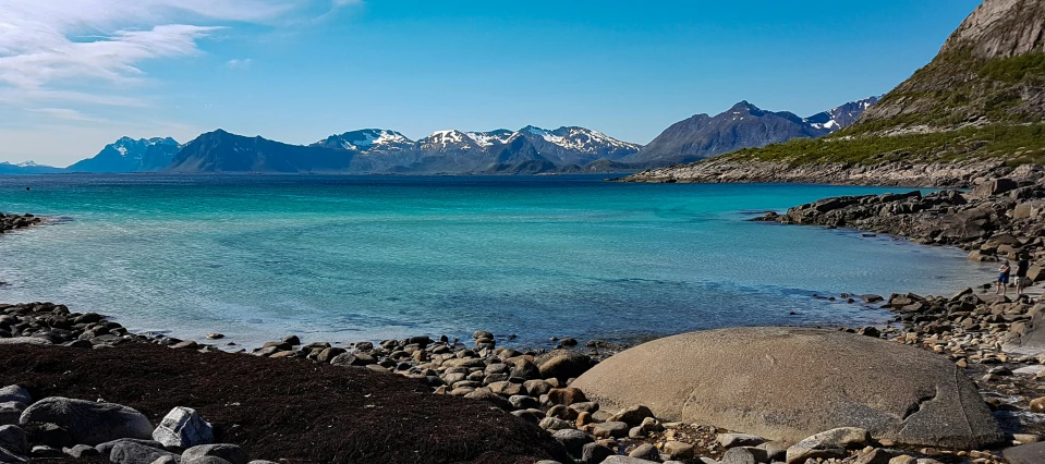 a body of water with a large boulder in front of it