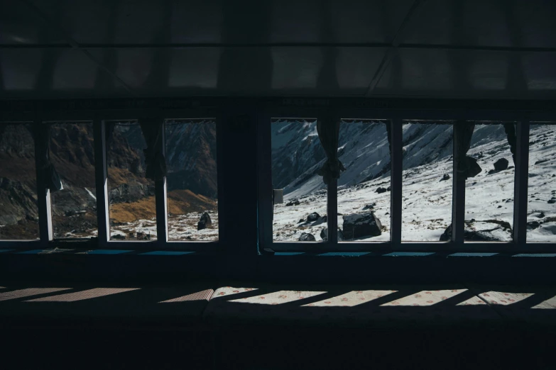 a window in a mountain with the snow outside