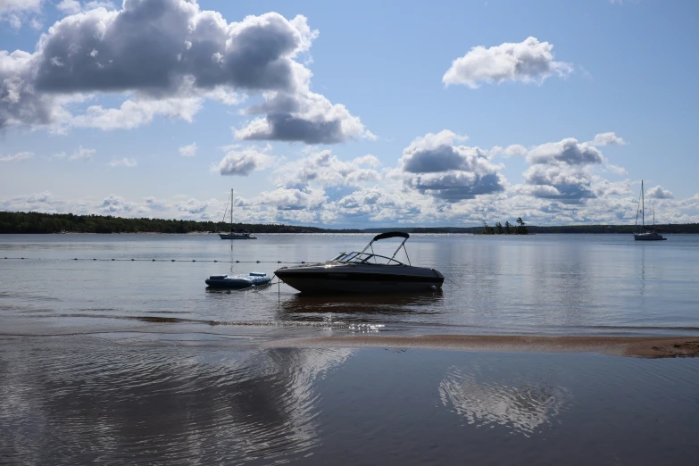 a boat docked at a beach near the shore