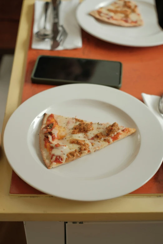 there is a plate of pizza and a fork on the table