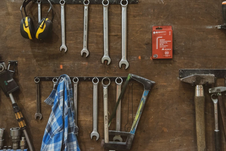 several tools lined up on a wall in the background