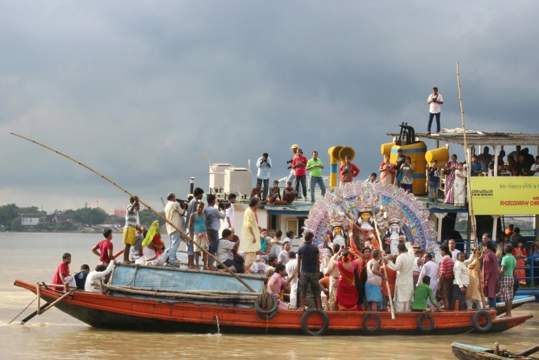 a group of people standing on the end of a boat