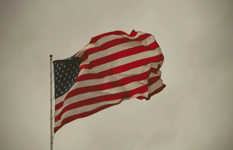 an american flag flies high in the sky