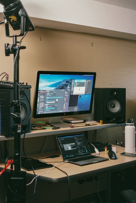 an office desk that has a laptop on it