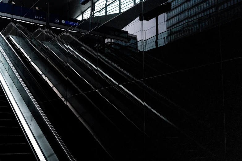 a lone man is walking along an escalator