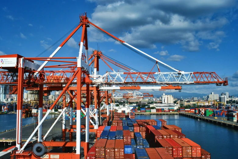 large cargo ships parked in a harbor next to buildings