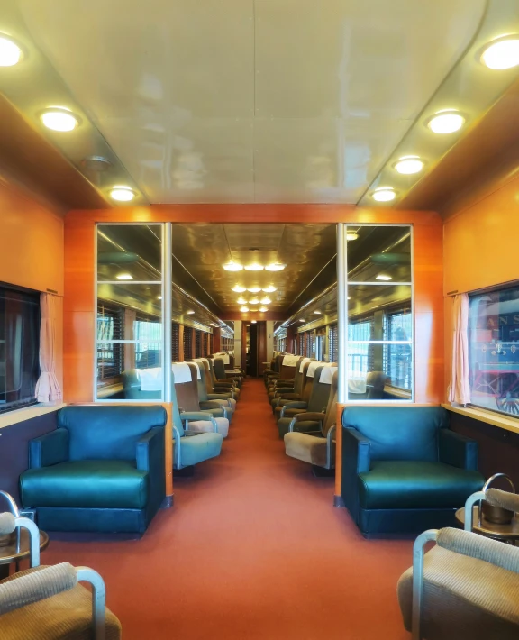 an empty passenger train car with chairs and other furniture