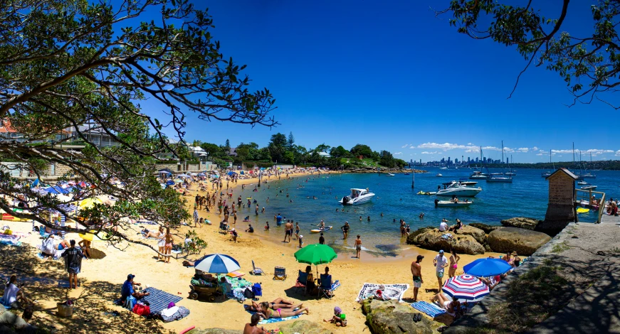 many people are walking and laying on the beach