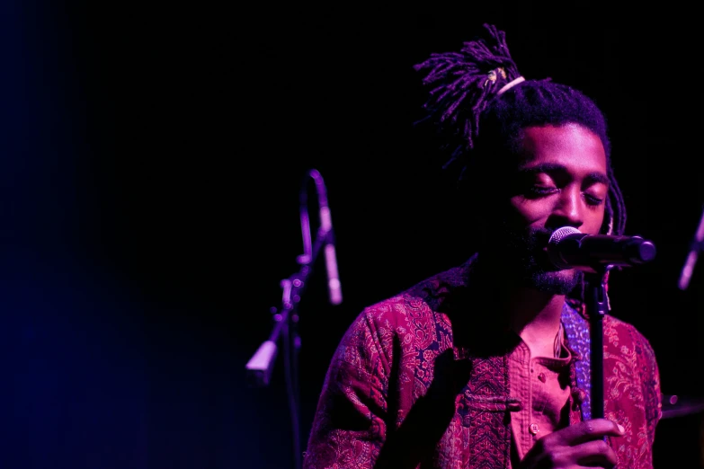 a person holding a microphone up to his mouth