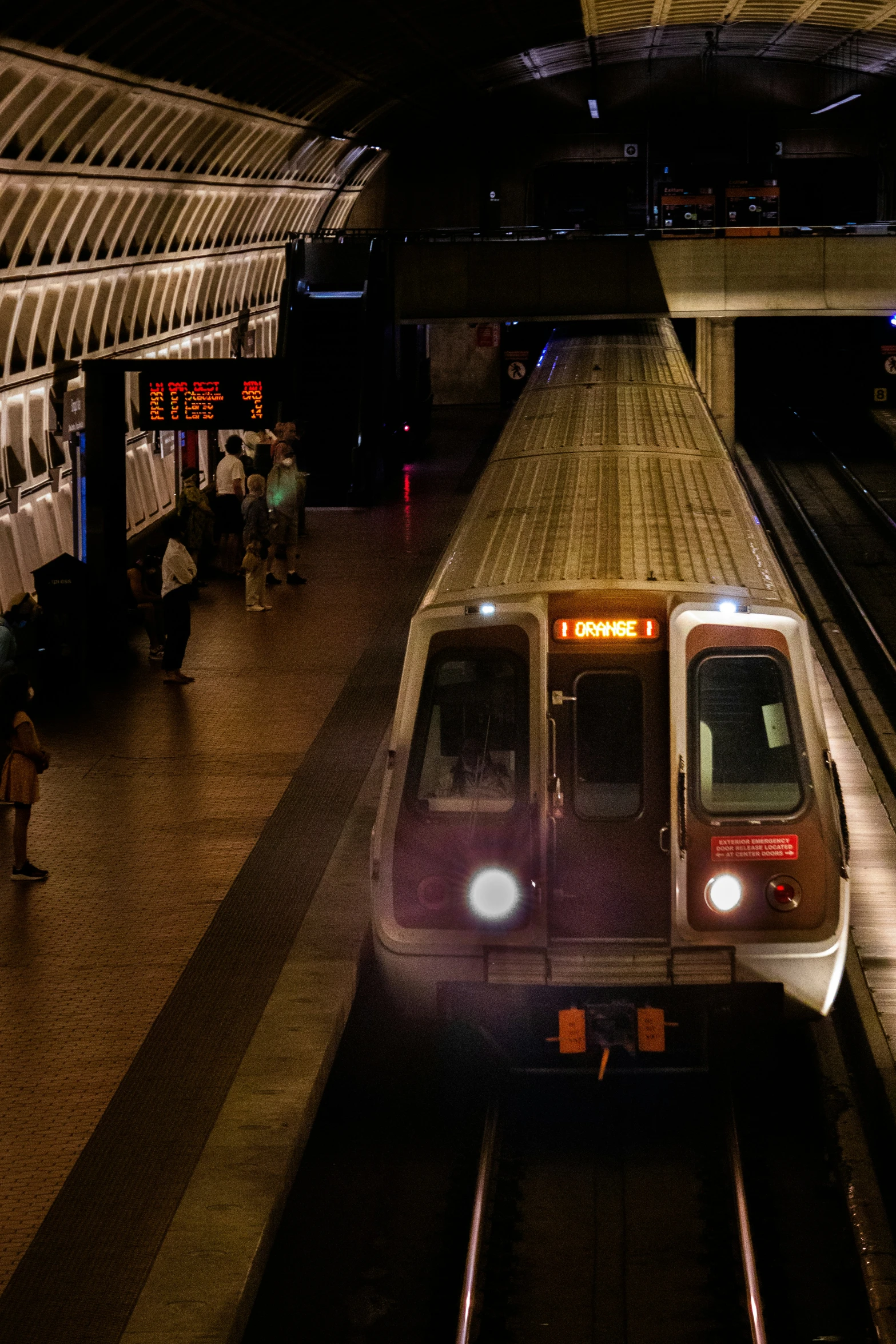 a subway train pulls up to the platform with passengers