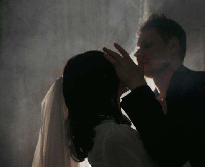 the bride and groom are kissing each other