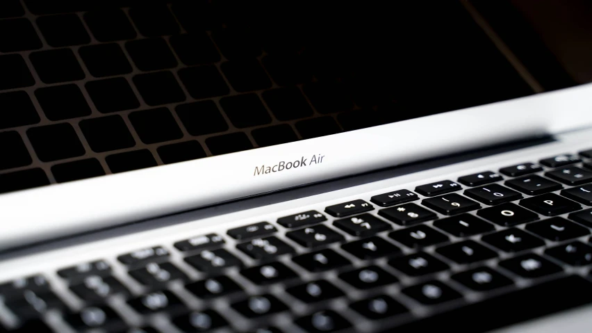 a laptop keyboard has white lettering on it