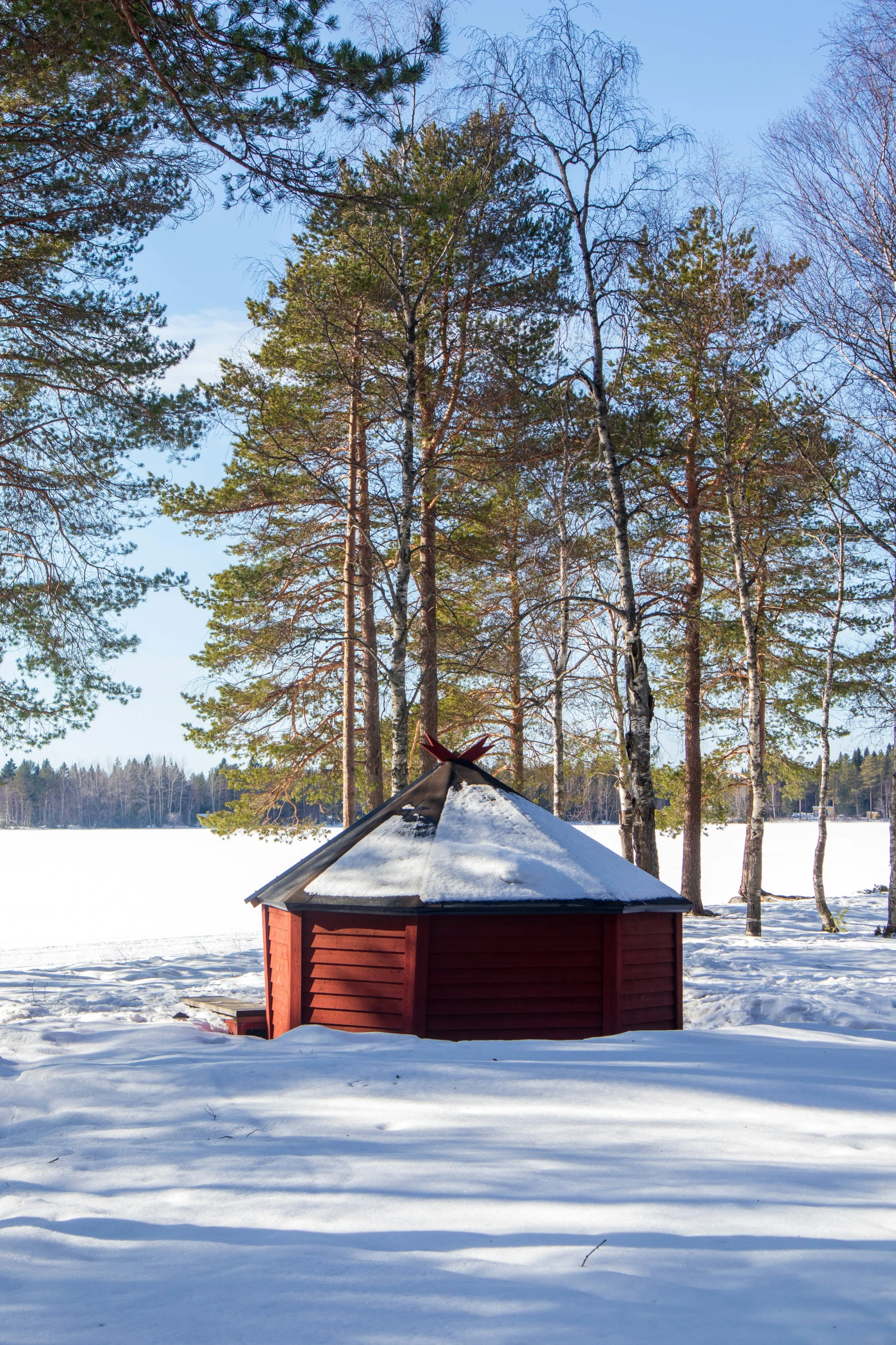 a wooden cabin is sitting in the middle of snow