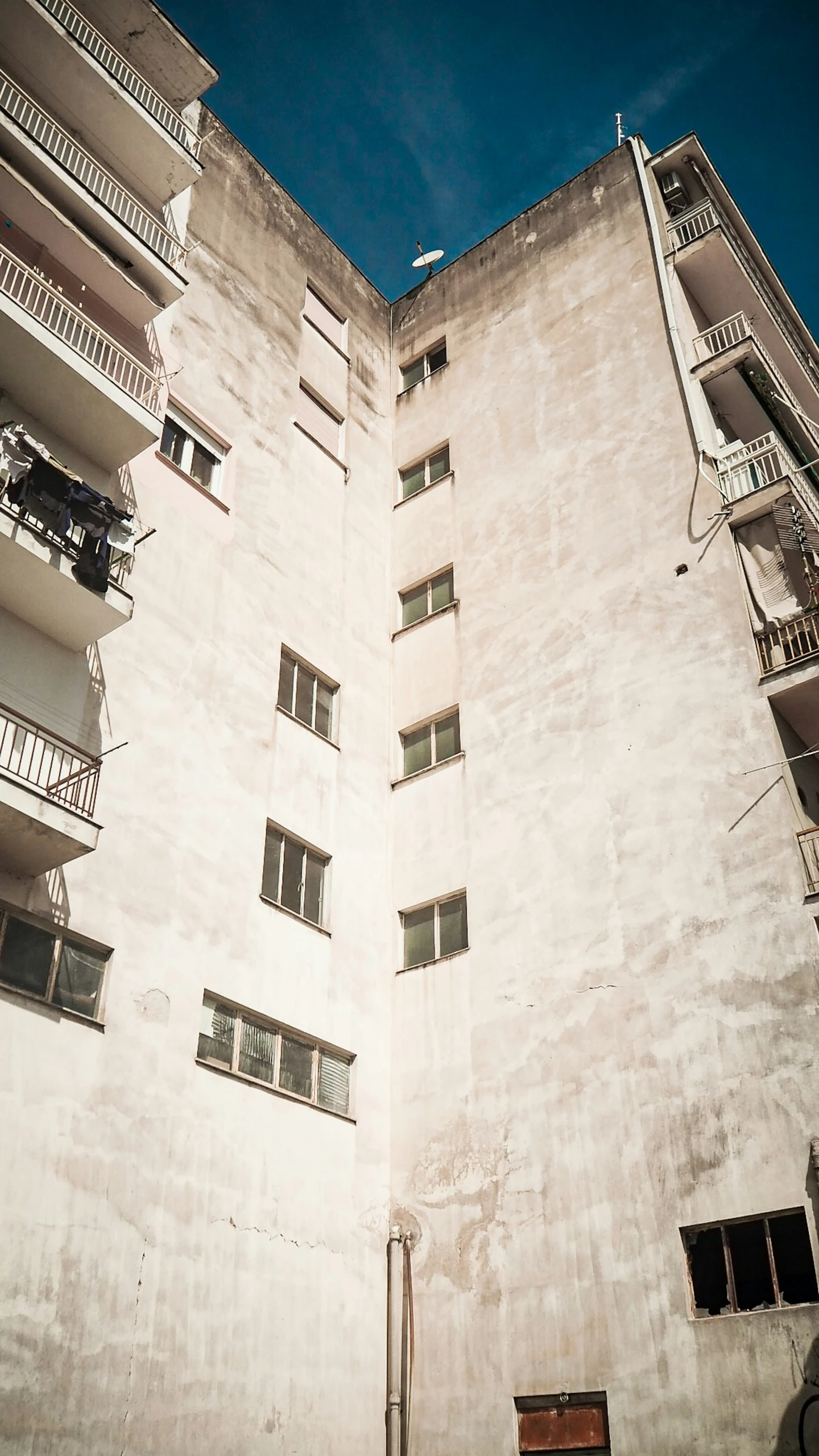 an apartment building with balconies and balconies and several windows