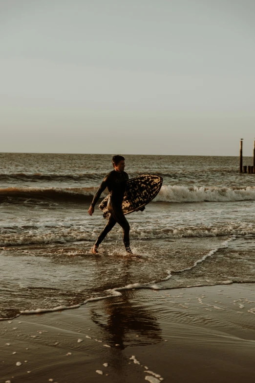 a surfer is carrying his board on the beach