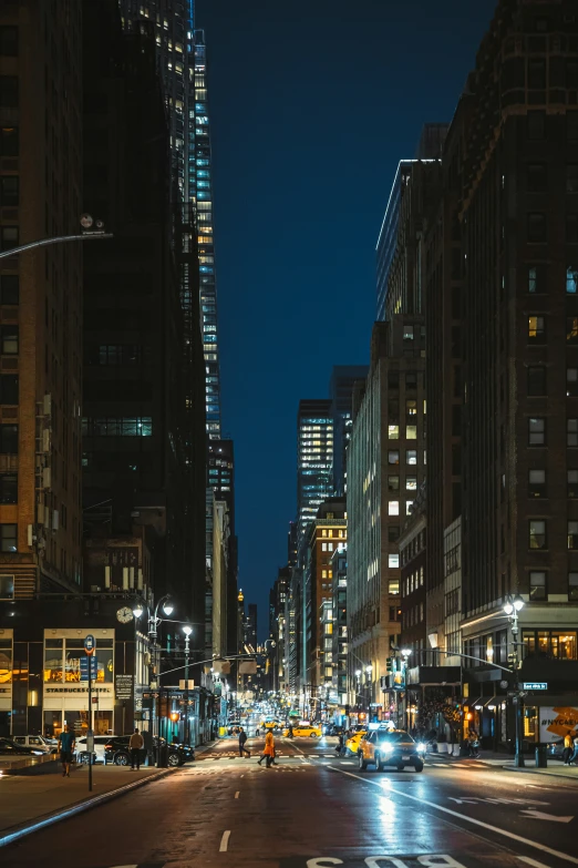 night time city scene with the lights of cars and buildings