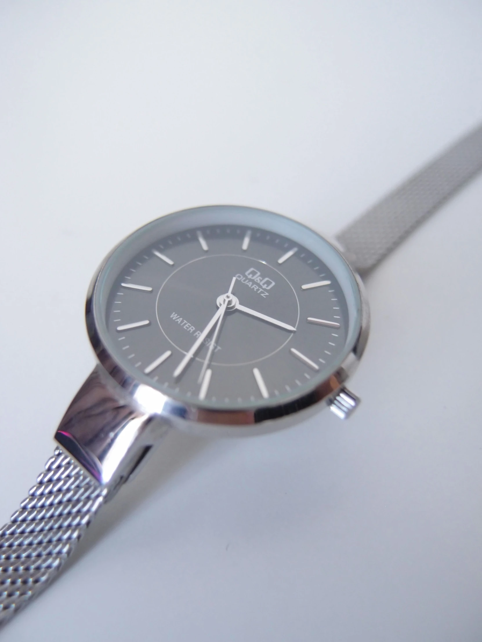 a wrist watch is placed on a white surface