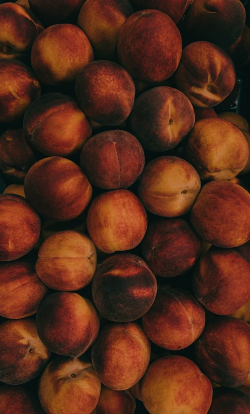 many peaches sitting on top of each other